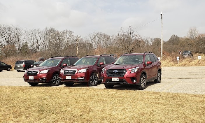 a photo of three red Subaru Foresters in a row
