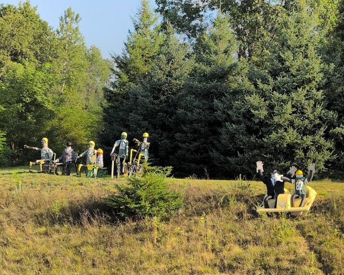 Lawn art: dummies made of drain pipe and dressed in football jersies and other old clothing, posed in the grass verge along Highway 54 a few miles west of Waupaca