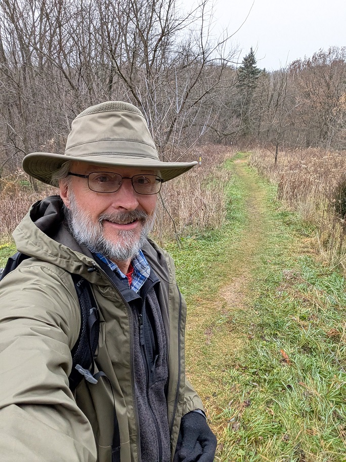 the author in a green hat and a green rain jacket.